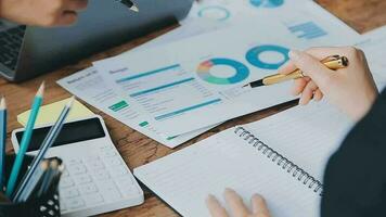 Financial analysts analyze business financial reports on a digital tablet planning investment project during a discussion at a meeting of corporate showing the results of their successful teamwork. video