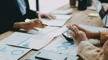 Financial analysts analyze business financial reports on a digital tablet planning investment project during a discussion at a meeting of corporate showing the results of their successful teamwork. video
