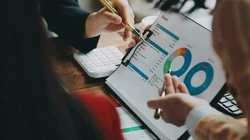 Financial analysts analyze business financial reports on a digital tablet planning investment project during a discussion at a meeting of corporate showing the results of their successful teamwork. video