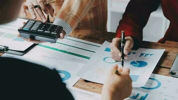 Financial analysts analyze business financial reports on a digital tablet planning investment project during a discussion at a meeting of corporate showing the results of their successful teamwork. video