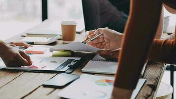 Financial analysts analyze business financial reports on a digital tablet planning investment project during a discussion at a meeting of corporate showing the results of their successful teamwork. video