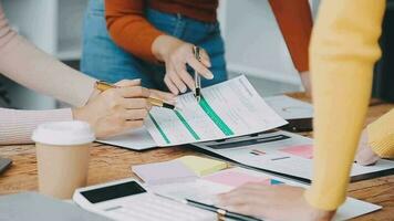 Financial analysts analyze business financial reports on a digital tablet planning investment project during a discussion at a meeting of corporate showing the results of their successful teamwork. video