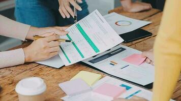 Financial analysts analyze business financial reports on a digital tablet planning investment project during a discussion at a meeting of corporate showing the results of their successful teamwork. video