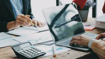 Financial analysts analyze business financial reports on a digital tablet planning investment project during a discussion at a meeting of corporate showing the results of their successful teamwork. video