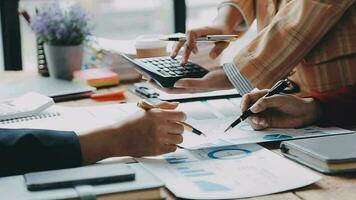 Financial analysts analyze business financial reports on a digital tablet planning investment project during a discussion at a meeting of corporate showing the results of their successful teamwork. video