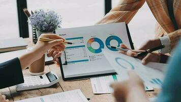 Financial analysts analyze business financial reports on a digital tablet planning investment project during a discussion at a meeting of corporate showing the results of their successful teamwork. video