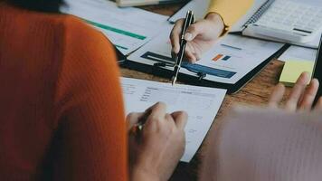 Financial analysts analyze business financial reports on a digital tablet planning investment project during a discussion at a meeting of corporate showing the results of their successful teamwork. video