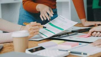 Financial analysts analyze business financial reports on a digital tablet planning investment project during a discussion at a meeting of corporate showing the results of their successful teamwork. video