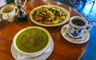 Green vegetable cream soup and vegetable fruit salad in Mexico. photo