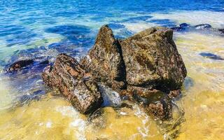 Beach sand blue turquoise water waves rocks panorama Puerto Escondido. photo