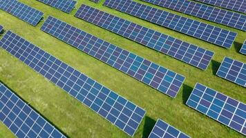 Flight over a field of solar panels in sunny summer day. Ecological innovation video