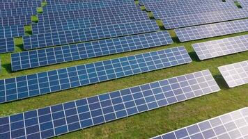 Flight over a field of solar panels in sunny summer day. Ecological innovation video