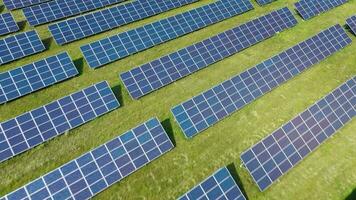 Flight over a field of solar panels in sunny summer day. Ecological innovation video