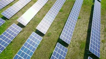 Flight over a field of solar panels in sunny summer day. Ecological innovation video