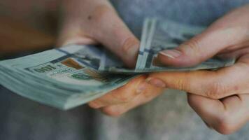 Female hand counting US Dollar bills, close-up video