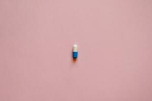 pill capsule on a pink background, medication, day of the medical worker, medical care, banner for the hospital photo