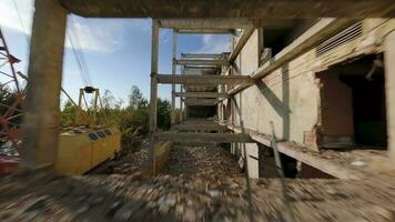 FPV drone flies quickly and agilely through an abandoned destroyed building. Post-apocalyptic location without people video