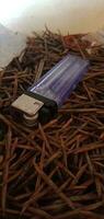 Object Photography - gas lighter on a pile of sticks photo