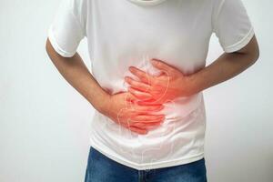 man having abdominal pain on white background photo