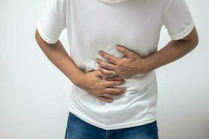 man having abdominal pain on white background photo