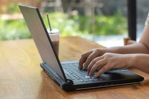 Male hands typing on laptop keyboard and surfing internet on desk, business concept and technology, internet network communication photo