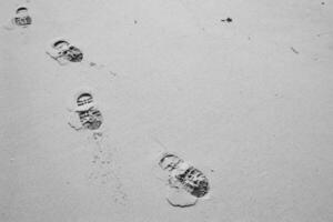 greyscale shot footprint on the sand photo