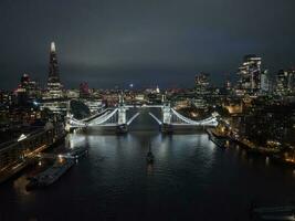 Aerial night view of the lifting up Tower Bridge in London. photo