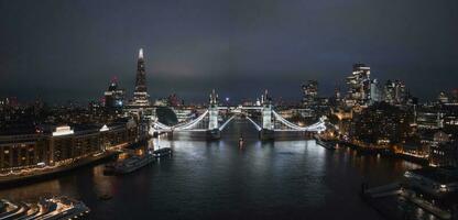 Aerial night view of the lifting up Tower Bridge in London. photo