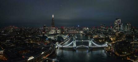 Aerial night view of the lifting up Tower Bridge in London. photo