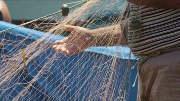 Slow Motion Elderly Fishermans Hand Cleaning Crops From Nets. video
