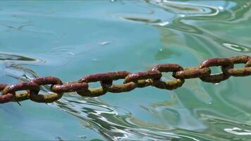 Rusty Chain Swinging Across Seawater Footage. video