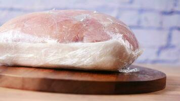 Raw chicken breast in a packet on table video