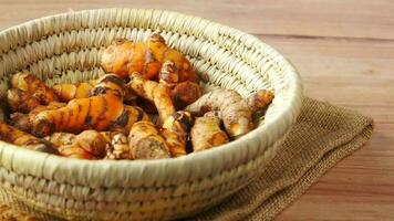 detail shot of turmeric root in bowl on table video