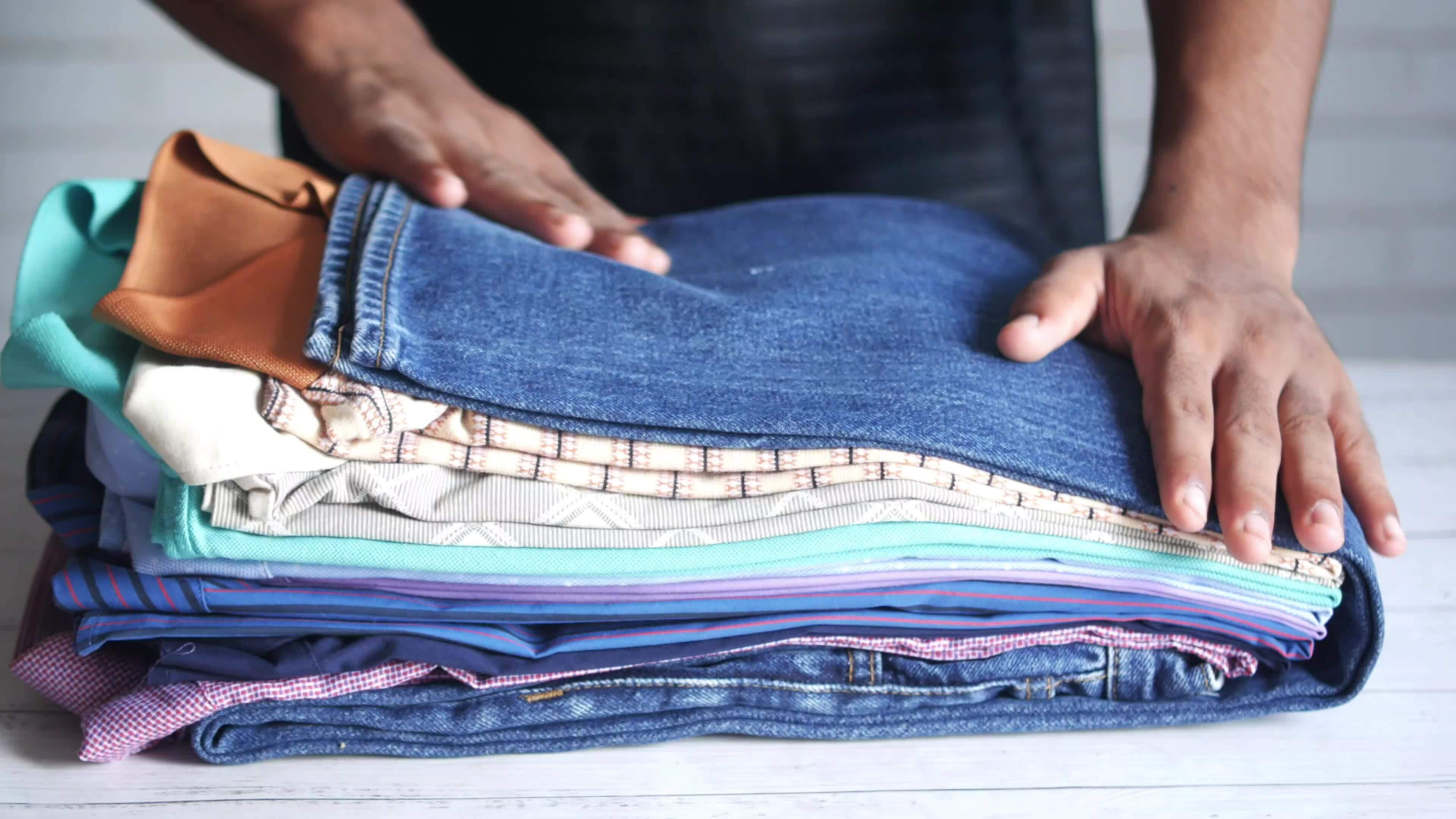 putting cloths on a table against wall background 24811146 Stock Video