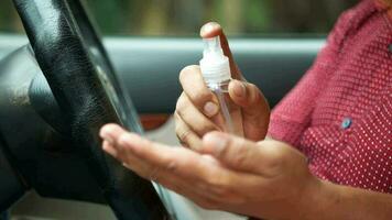 close up of young man hand using hand sanitizer spray in a car video