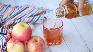 Glass of apple juice and apple on table video