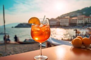 Glass of fresh aperol spritz on wooden table at bar and beach photo