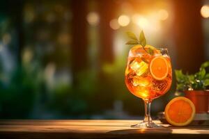 Glass of fresh aperol spritz on wooden table at bar and beach photo