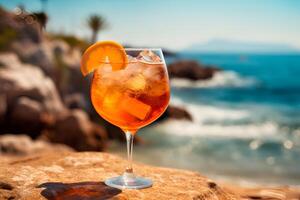 Glass of fresh aperol spritz on wooden table at bar and beach photo