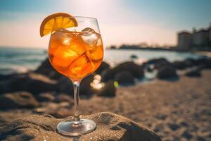 Glass of fresh aperol spritz on wooden table at bar and beach photo