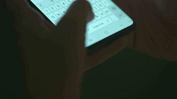 Female hands typing text on smartphone close-up. Using smartphone close up in the evening video