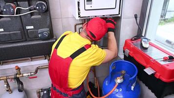 June 1, 2021. Krakow, Lesser Poland. Residential Heating Systems Technician Performing Scheduled Maintenance on the Gas Heating System. video