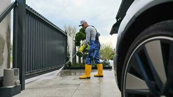 Man Pressure Washing Concrete Slab Driveway video
