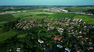 Aerial orbiting view of a village with castle and green trees video