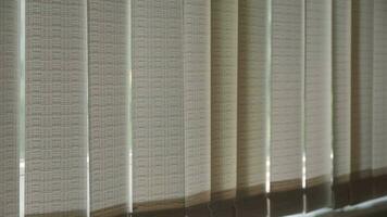 Vertical blinds block out sunlight. Inside view. video