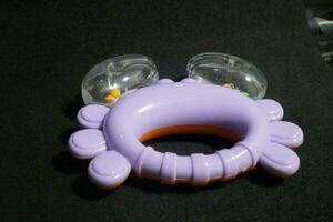 Purple crab toy with small balls inside photo