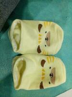 Cute baby socks in yellow and a guinea pig face photo