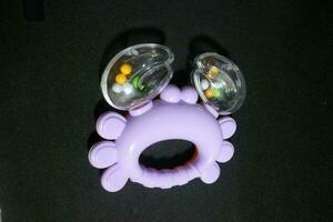 Purple crab toy with small balls inside photo