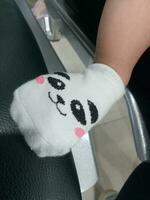 Photo of a baby's foot in a sock with a cute panda face on it