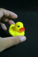 Cute little yellow toy duck with red lips photo